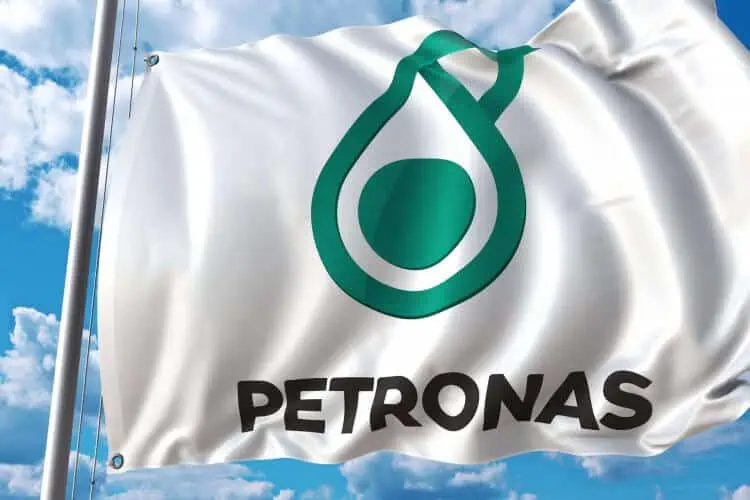 Petronas flag waving against blue sky.