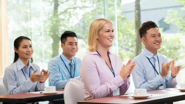 People clapping during a business meeting
