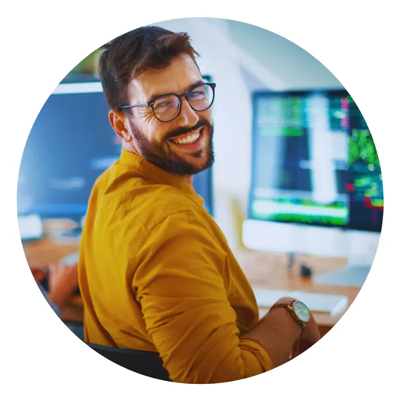 Smiling developer at computer workstation