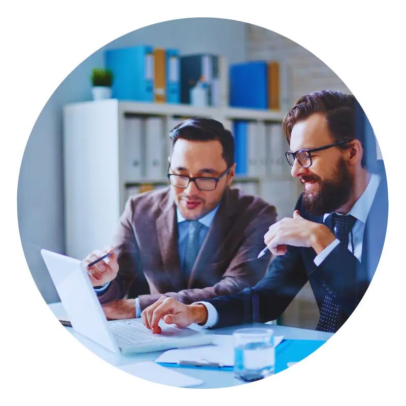 Two businessmen discussing work on a laptop