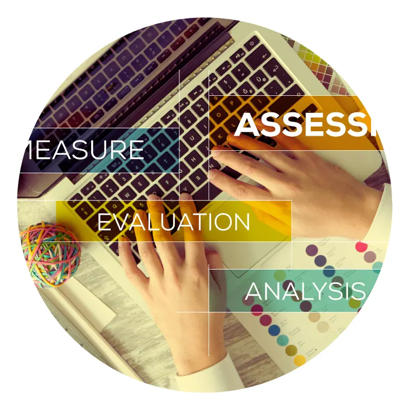 Hands typing on laptop with analysis keywords.